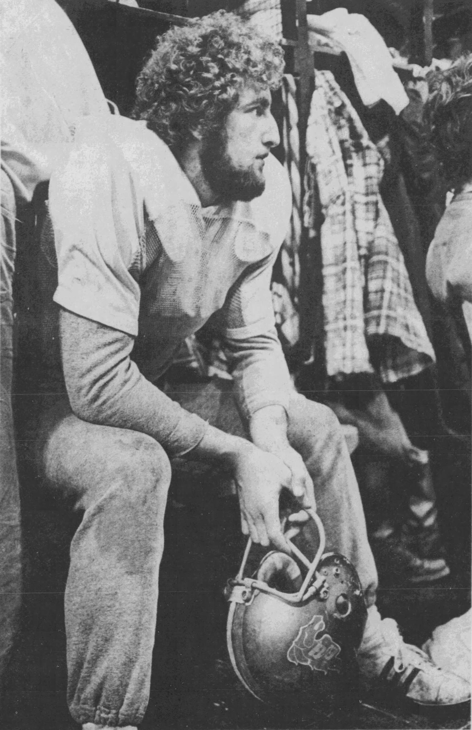 Mike Murphy sits in locker room with helmet in hands.