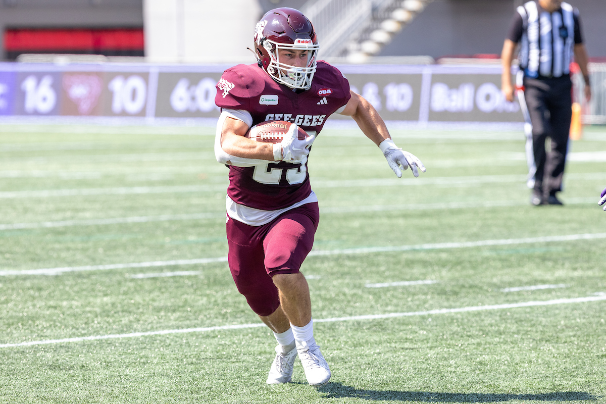 Charles Asselin carries the football at TD Place stadium.