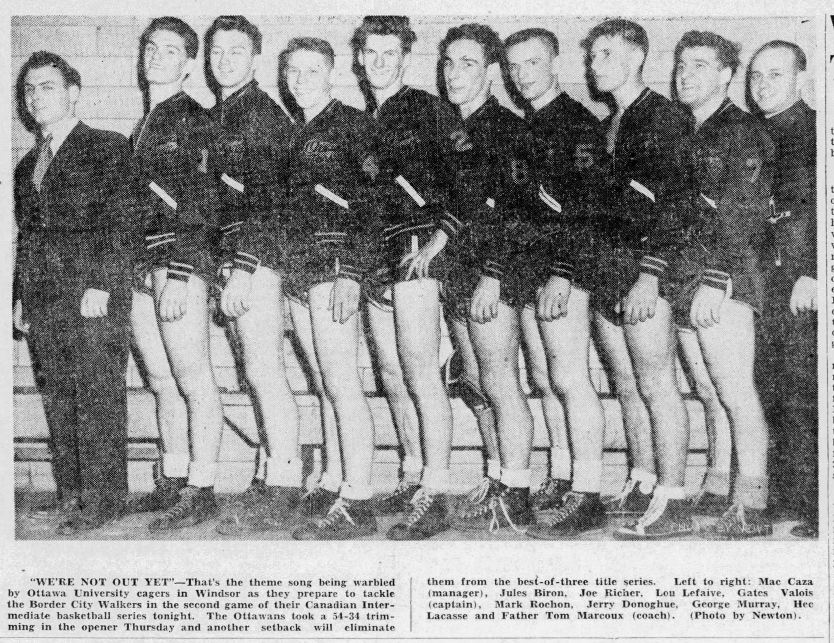 Black and white newspaper clipping - 10 members of the basketball team take a team photo.
