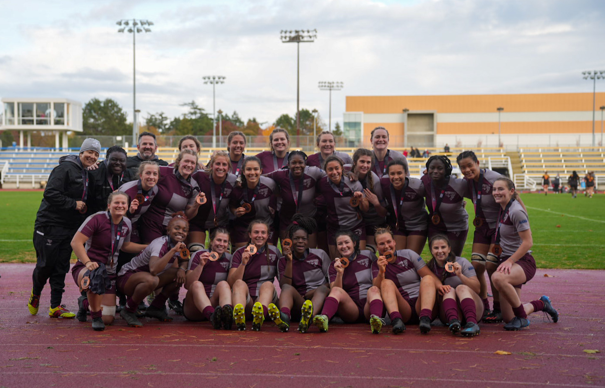 Gee-Gees women's rugby team players and coaches with their national bronze medals.