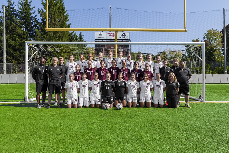 Team photo of the 2014 Gee-Gees women's soccer team players and staff. Photo taken on Matt Anthony Field.