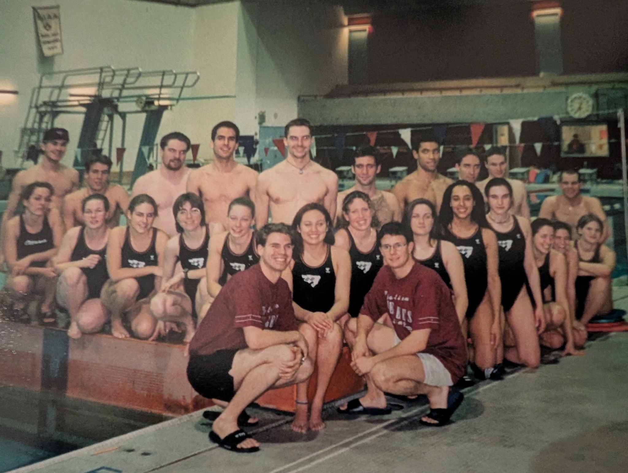Gee-Gees swimming team poses on the pool deck.