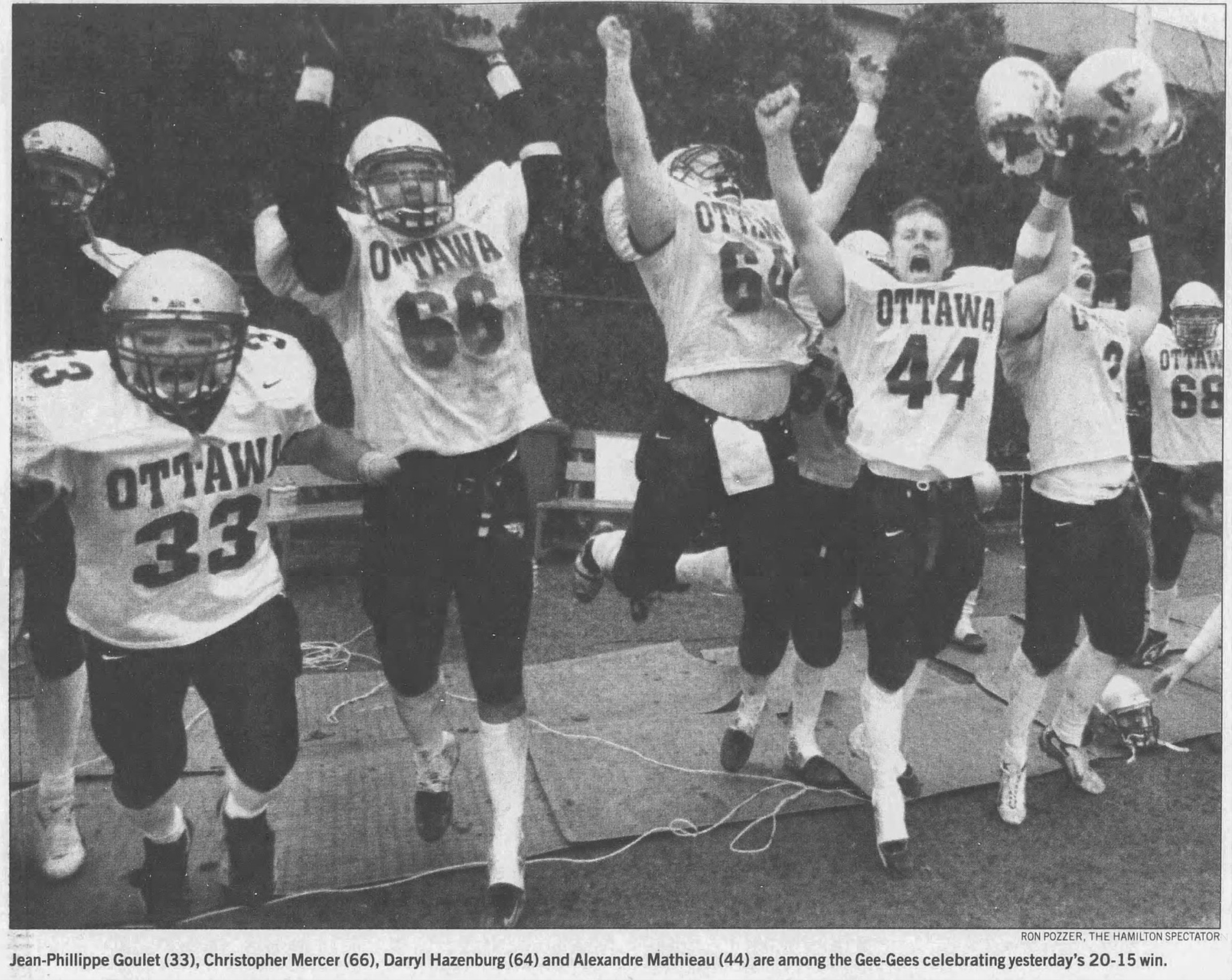 Black and white newspaper clipping of a photo of Gee-Gees players celebrating on the bench. Caption of photo reads Jean-Phillippe Goulet (33), Christopher Mercer (66), Darryl Hazenburg [sic] (64) and Alexandre Mathieau (44) are among the Gee-Gees celebrating yesterday's 20-15 win.